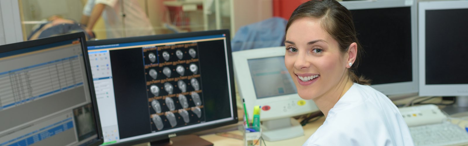 Femaie healthcare administrator sitting at desk smiling