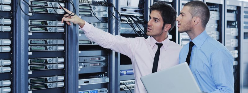 Information technology professionals inspecting server racks