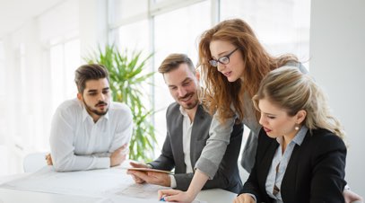 Female leading group of business professionals in office