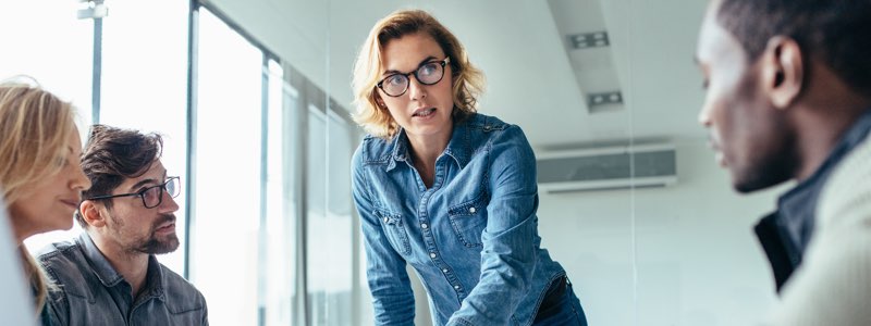 Female leading group discussion in office