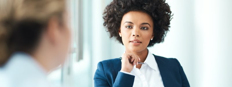 Female legal professional shaking client's hand and smiling