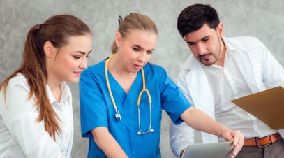 Nurses and doctor looking at laptop