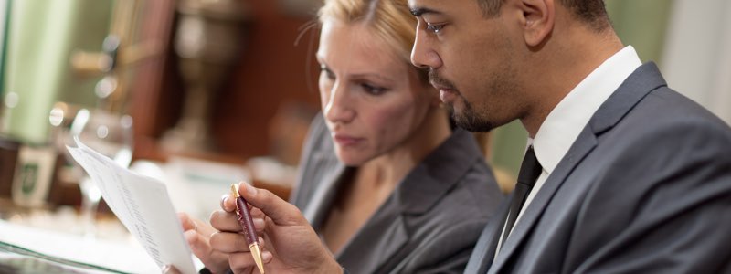 Female and male reviewing legal documents