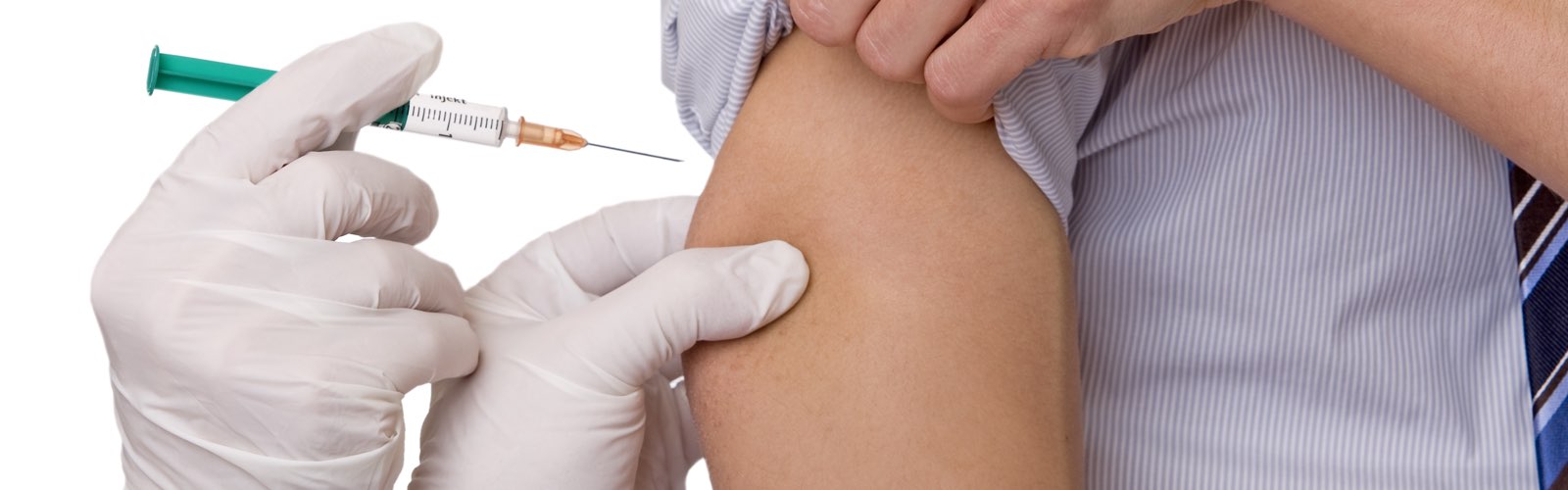 Nurse giving a vaccination in upper arm