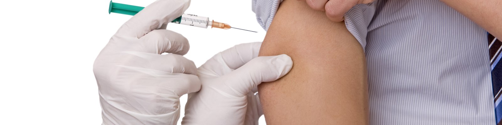 Nurse giving a vaccination in upper arm
