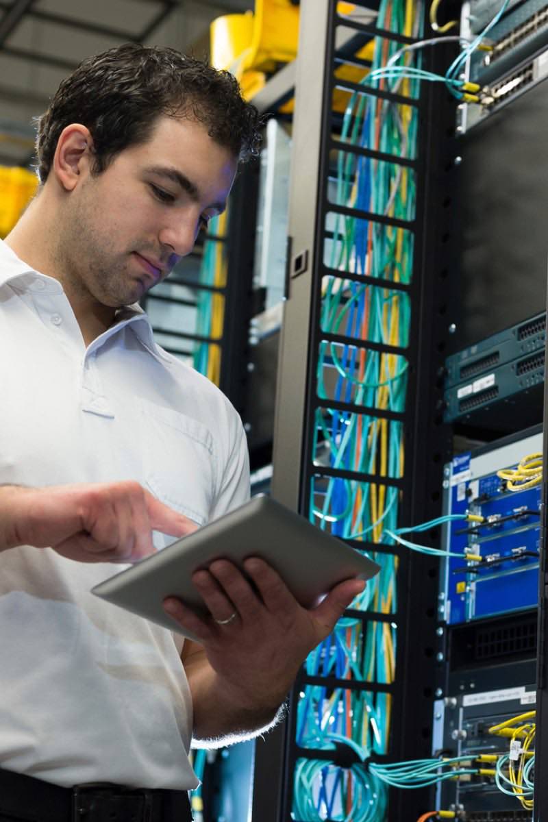 Information technology professionals inspecting server racks