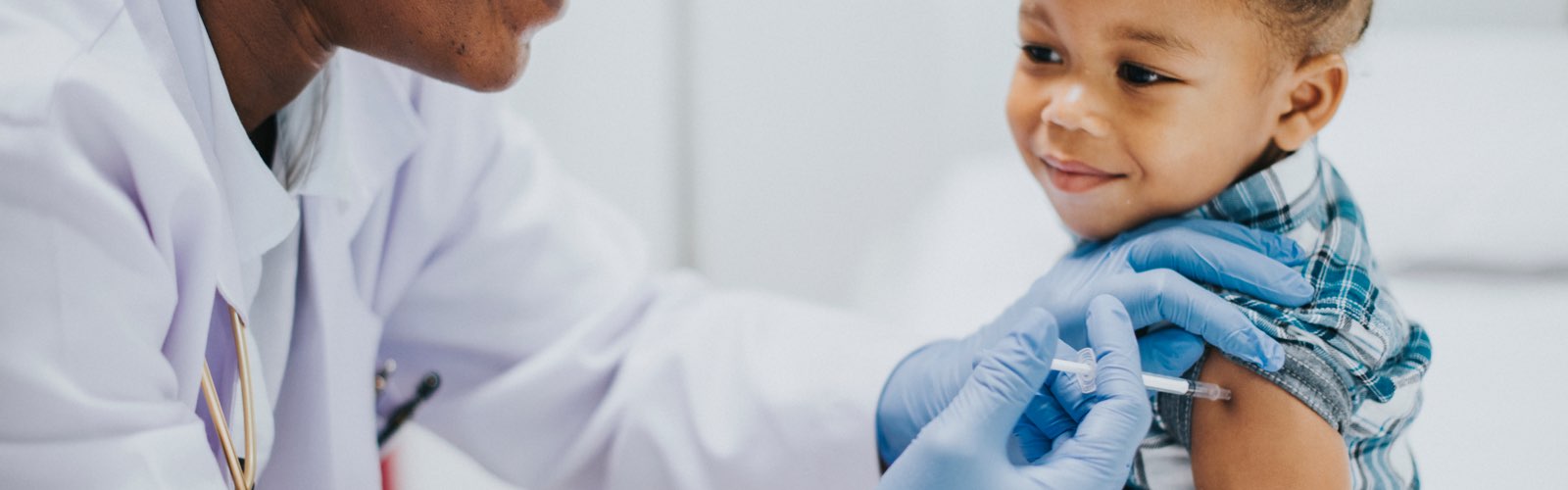 Female nurse giving child a vaccination