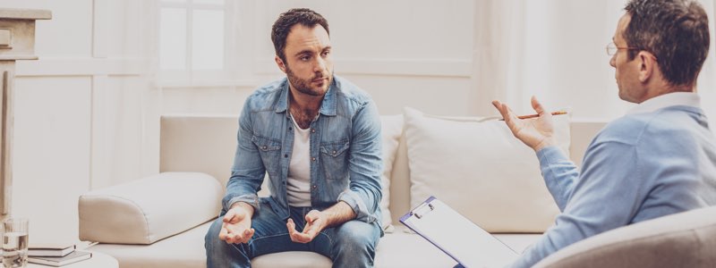 Male counselor speaking to patient