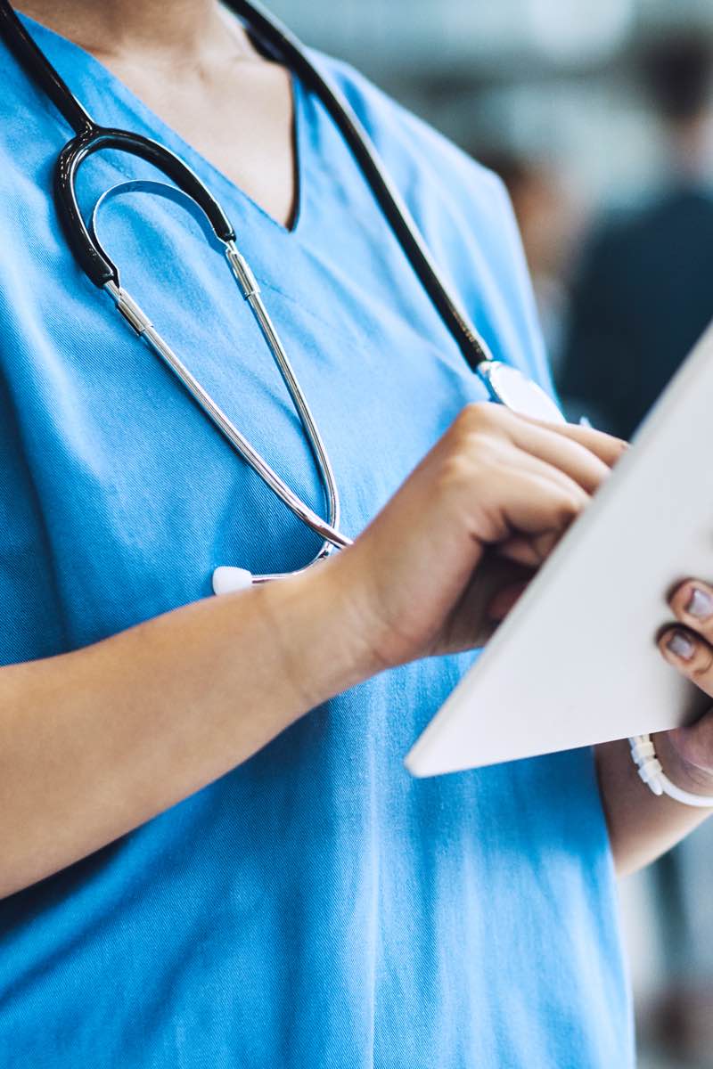 Nurse looking at medical records on tablet