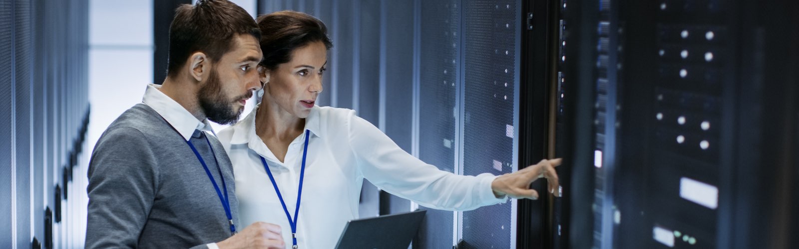 Information technology professionals inspecting server racks