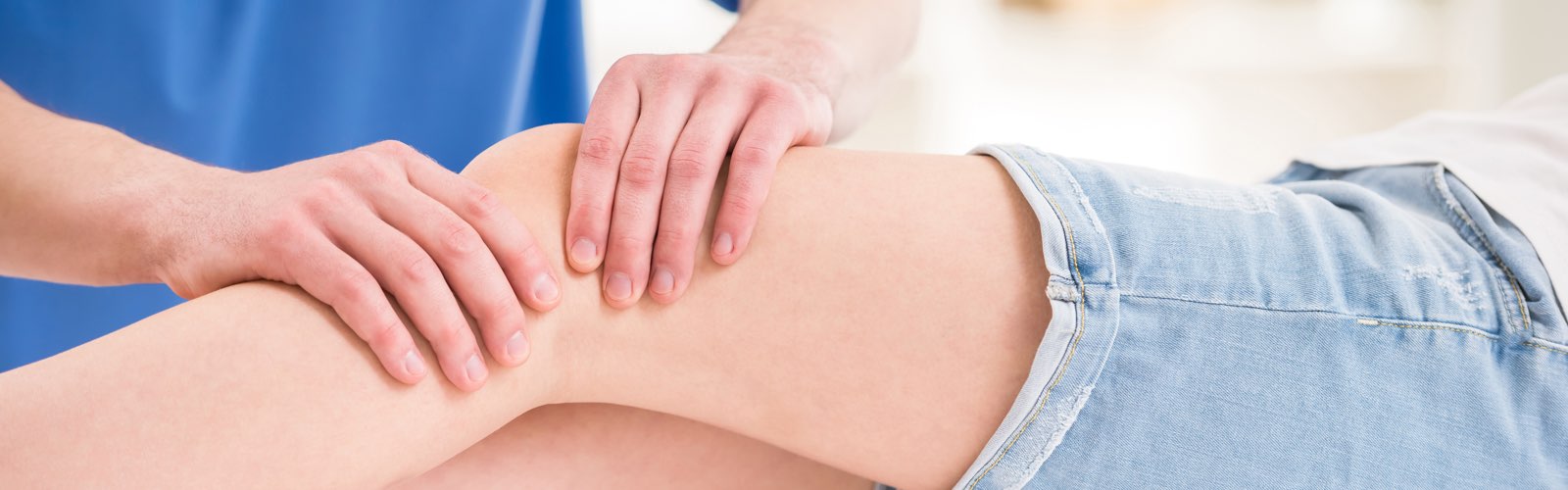 Occupational therapist massaging patient's knee