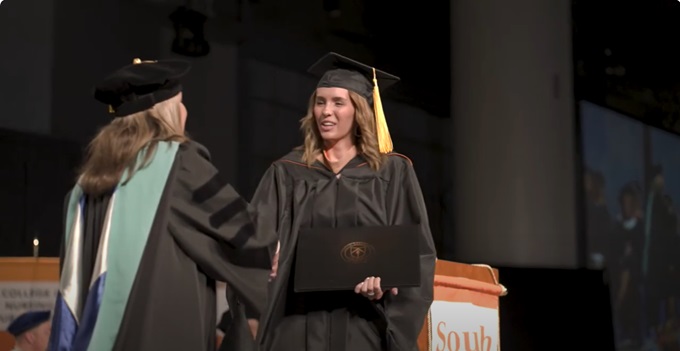 Raschelle Gordon receiving her MBA diploma at a South University graduation ceremony
