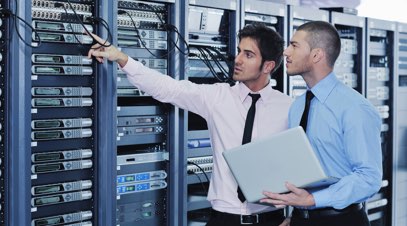 Information technology professionals inspecting server racks