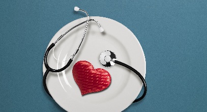 plate with a heart shaped object and stethescope on it