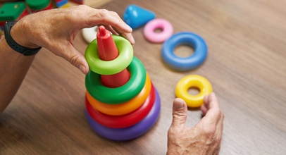 person playing with a plastic children's ring toy