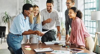 group of young professionals discussing a business project standing around a conference table