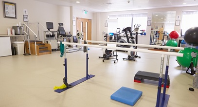 physical therapy gym equipment in a large gym room