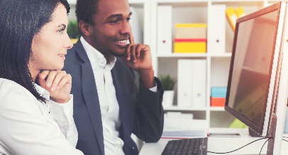 Man and woman analyzing data on computer screen