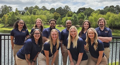 group of PTA students posing in their blue South polos outside
