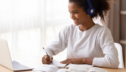 young african american girl researching information on her laptop