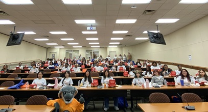group of high school students at South University scrubs camp sitting in a classroom together for a group photo