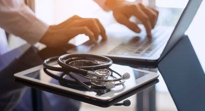 stethiscope laying on top of a tablet