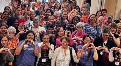 group of people posing for a photo at a breast cancer seminar