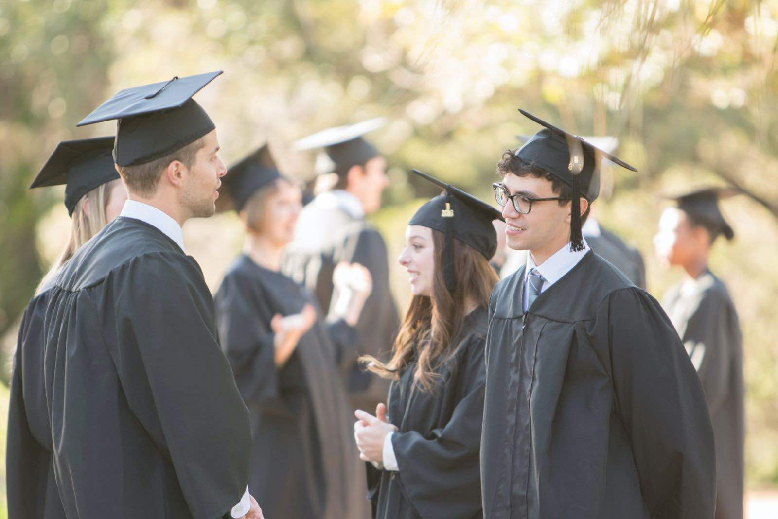 Graduates speaking with each other