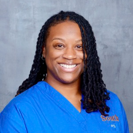 Raven Boswell headshot smiling in blue scrubs